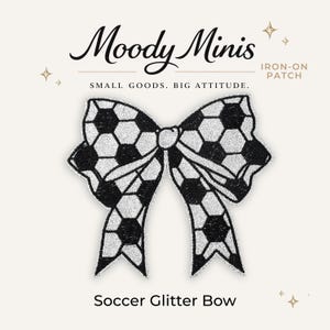 May include: An iron-on patch shaped like a bow with a black and silver glitter soccer ball pattern. The text Moody Minis, IRON-ON PATCH, SMALL GOODS. BIG ATTITUDE., and Soccer Glitter Bow are printed around the bow graphic on a light background.