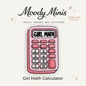 May include: An iron-on patch shaped like a pink calculator with white buttons. The screen displays the text GIRL MATH in black letters. The calculator features numbers 3, 4, 5, 6, 7, 8, 9 and a heart symbol on the keypad. The patch has a white border.
