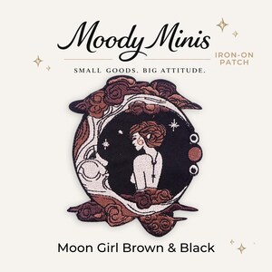 May include: An iron-on patch featuring a circular design with a person in profile surrounded by a crescent moon and clouds in shades of brown and black. The text Moody Minis, Small Goods. Big Attitude., Iron-On Patch, and Moon Girl Brown & Black are visible.
