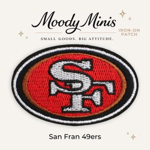May include: An oval-shaped iron-on patch featuring the San Francisco 49ers logo in red, white, and black embroidery. The design includes a silver-grey interlocking SF monogram centered on a red oval background, bordered by a thick black edge.