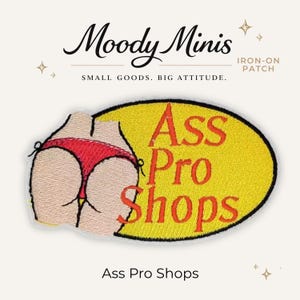 May include: An oval-shaped iron-on patch featuring an embroidered illustration of a person wearing a red thong bikini bottom. The design includes the text Ass Pro Shops in red lettering against a yellow background with a black border outline.