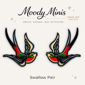 May include: Two embroidered iron-on patches featuring swallows in flight. The birds have black, red, green, and yellow thread details. Above the birds, the text reads Moody Minis IRON-ON PATCH SMALL GOODS. BIG ATTITUDE. Below the birds, the text reads Swallow Pair.
