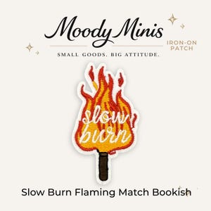 May include: An embroidered iron-on patch featuring a matchstick with a large flame in shades of yellow, orange, and red. The words "slow burn" are stitched in white cursive across the center of the flame. The matchstick has a dark brown base.