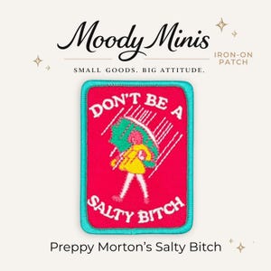 May include: A rectangular iron-on patch with a bright pink background and a teal border. The patch features a graphic of a figure in a yellow coat holding a green umbrella in the rain. The white text reads DON'T BE A SALTY BITCH.