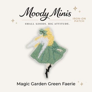 May include: An embroidered iron-on patch featuring a figure with yellow hair, a green dress, and white wings. The text Moody Minis, IRON-ON PATCH, SMALL GOODS. BIG ATTITUDE., and Magic Garden Green Faerie are printed around the central patch design.