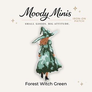 May include: An embroidered iron-on patch featuring a figure wearing a wide-brimmed hat and a long dress in shades of forest green and light mint. The figure has long reddish-brown hair and is shown from the back. Text reads Moody Minis.