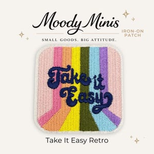 May include: A square iron-on patch featuring vertical rainbow stripes in pink, orange, yellow, olive green, light blue, and purple. The dark blue embroidered text reads Take it Easy in a cursive font. The patch has a white border and rounded corners.