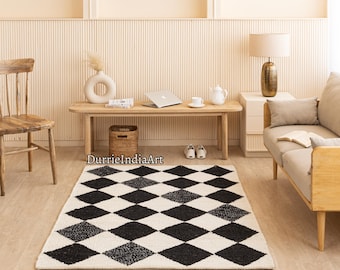 May include: A black and white checkered rug with a diamond pattern. The rug is in a living room setting with a wooden bench, a lamp, and a couch.