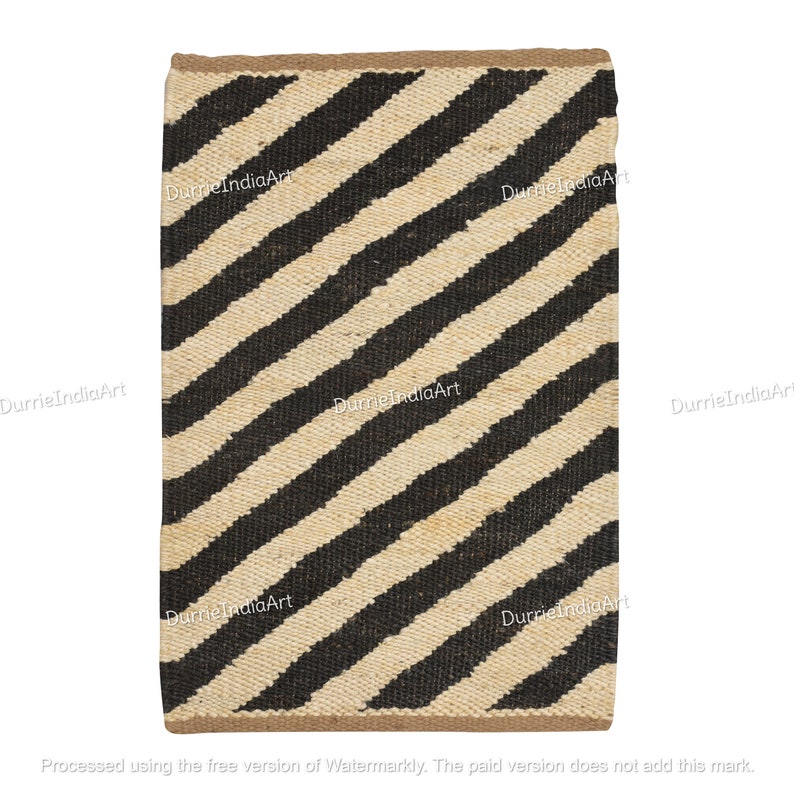 May include: A black and white striped jute rug with a diagonal pattern. The rug is made of natural fibers and has a rustic look.