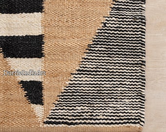 May include: A black and white striped jute rug with a geometric pattern. The rug is made of natural fibers and has a rustic look.