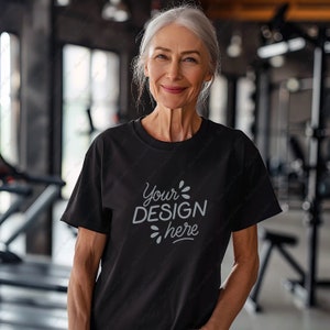 May include: A black t-shirt with the text "Your DESIGN here" in a gray font.