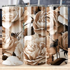 May include: Three stainless steel tumblers with a floral design. The tumblers feature a pattern of beige and brown roses on a white background.