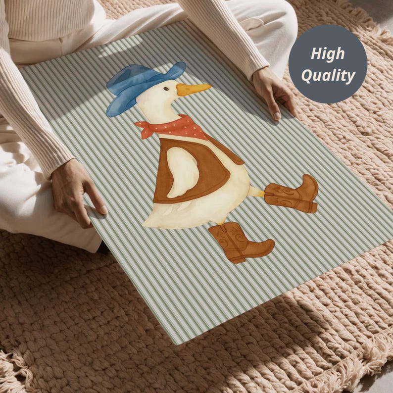 May include: A rectangular decorative panel featuring a watercolor illustration of a cartoon duck dressed as a cowboy. The duck wears a blue hat, red bandana, brown vest, and cowboy boots. The background has a striped pattern.