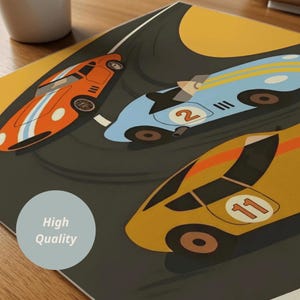 May include: A graphic print featuring three race cars on a dark track. An orange car with white stripes, a light blue car with the number 2, and a yellow car with the number 11 are depicted. A circular badge with the text High Quality is visible.