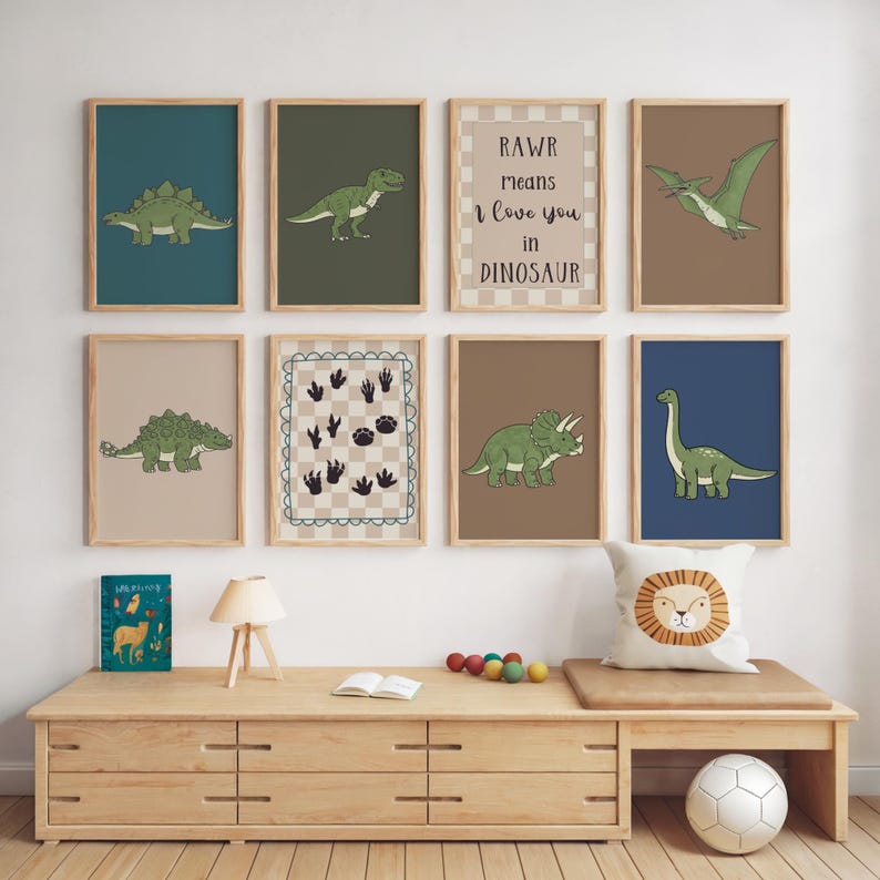 May include: A collection of eight framed dinosaur-themed art prints. Each print features a different dinosaur illustration in green and brown tones, with a variety of backgrounds. One print reads "RAWR means I love you in Dinosaur."