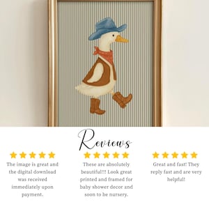 May include: Framed artwork featuring a whimsical illustration of a goose dressed as a cowboy. The goose wears a blue hat, red bandana, brown vest, and cowboy boots. The background has vertical stripes. The frame is gold.