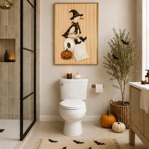 May include: A framed wall art print featuring a white duck wearing a black witch hat, cape, and boots, sitting on a roll of toilet paper next to a jack-o'-lantern pumpkin. The background of the print has vertical tan stripes.