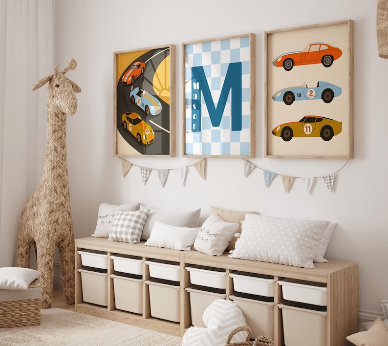 May include: Three framed wall art prints featuring race cars and the letter M with the name Mason. The left print shows cars on a track, the center has a blue checkered pattern with the letter M, and the right shows three stacked race cars.