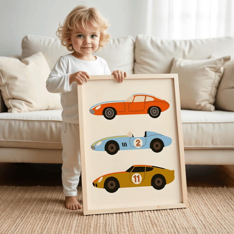 May include: A framed wall art print featuring three vintage-style race cars stacked vertically. The top car is orange, the middle light blue car displays the number 2, and the bottom mustard yellow car features the number 11 in a white circle.