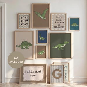 May include: A collection of framed dinosaur-themed art prints. The prints feature various dinosaurs in green and brown tones, with text that reads "RAWR means I love you in Dinosaur" and "Little man cave".