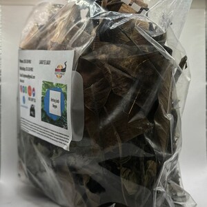 May include: A clear plastic bag filled with dried brown and green leaves. The bag has a label that says "KEEPTOWAY" and "Herbs Bath  Recipes".