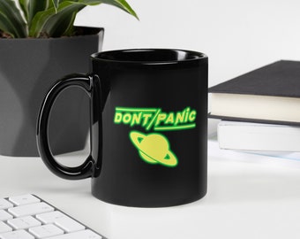 Taza de ciencia ficción "Don't Panic" – Guía del autoestopista galáctico, color negro brillante (11 oz o 15 oz)