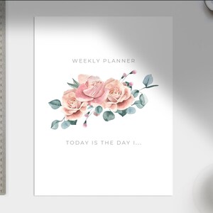 May include: A weekly planner with a floral design featuring pink roses and green leaves. The text "TODAY IS THE DAY I..." is printed below the floral design.