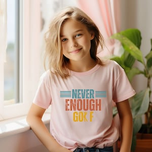 May include: A pink t-shirt with a retro-style graphic that says "Never Enough Golf" in blue, orange, and yellow text.