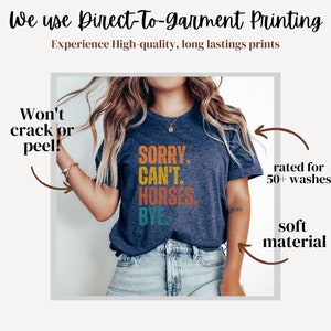May include: A navy blue t-shirt with a colorful graphic that reads "SORRY. CAN'T. HORSES. BYE". The shirt is made with a soft material and is rated for 50+ washes.