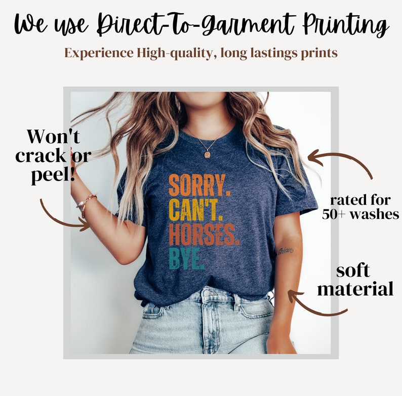 May include: A navy blue t-shirt with a colorful graphic that reads "SORRY. CAN'T. HORSES. BYE". The shirt is made with a soft material and is rated for 50+ washes.
