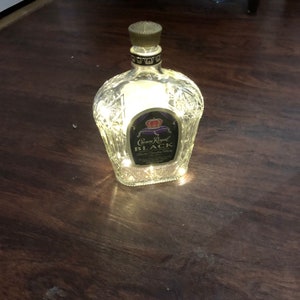 Upcycled 750 ml Crown Royal Black bottle with mini LED lights! Gorgeous bottle details.