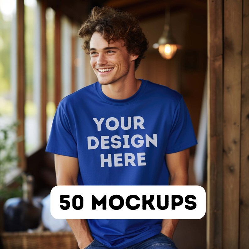 May include: A man wearing a blue t-shirt with the text "YOUR DESIGN HERE" printed on the front. The image is a mockup for a t-shirt design.