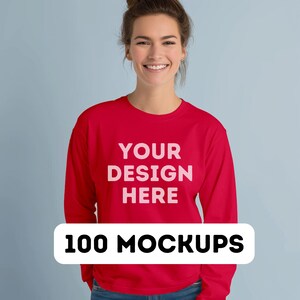 May include: A red long-sleeved sweatshirt with the text "YOUR DESIGN HERE" printed on the front. 100 MOCKUPS.