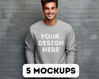 May include: A grey sweatshirt with the text "YOUR DESIGN HERE" printed on the front. 5 MOCKUPS.