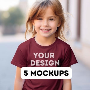 Può includere: Una persona giovane indossa una maglietta color granata con la scritta "YOUR DESIGN" e "5 MOCKUPS" stampata sul davanti.