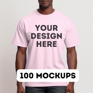 May include: A pink t-shirt with the text "YOUR DESIGN HERE" printed on the front. 100 MOCKUPS.