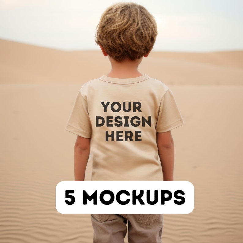 May include: A beige t-shirt with the text "YOUR DESIGN HERE" printed on the back. The t-shirt is being worn by a child standing in a desert landscape. 5 MOCKUPS.