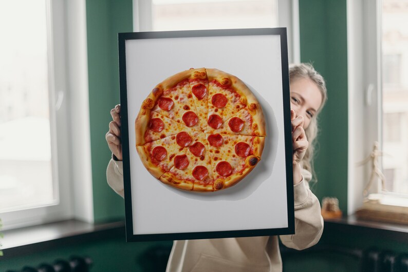 K&ouml;nnte beinhalten: Ein gerahmter Druck einer Pepperoni-Pizza auf wei&szlig;em Hintergrund. Die Pizza hat einen goldenen Rand und ist mit geschmolzenem K&auml;se und Pepperoni-Scheiben belegt.