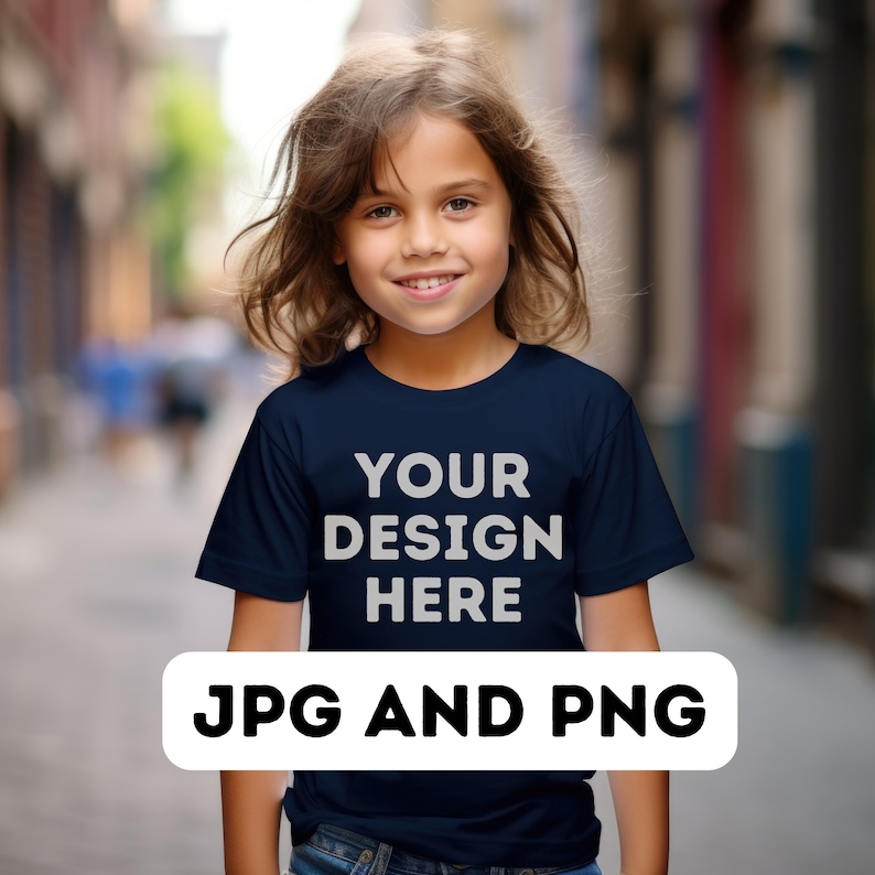 May include: A young person wearing a dark blue t-shirt with the text "YOUR DESIGN HERE" printed on the front. The t-shirt is a mockup for a custom design.