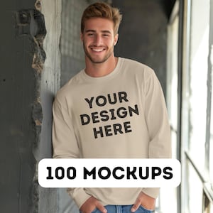 May include: A beige long-sleeve sweatshirt with the text "YOUR DESIGN HERE" printed on the front.
