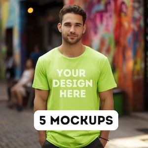 May include: A man wearing a bright green t-shirt with the text "YOUR DESIGN HERE" printed on the front. The t-shirt is a mockup for a design project. 5 MOCKUPS is written in white text on a black rectangle at the bottom of the image.
