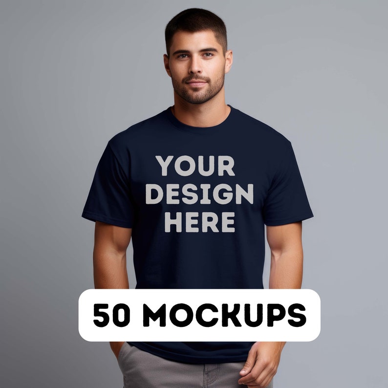 May include: A navy blue t-shirt with the text "YOUR DESIGN HERE" printed in white on the front. 50 MOCKUPS.