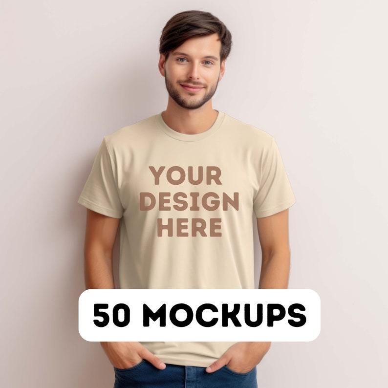 May include: A beige t-shirt mockup with the text "YOUR DESIGN HERE" printed on the front. The t-shirt is being worn by a person with short brown hair. The text "50 MOCKUPS" is printed in black on a white oval shape.