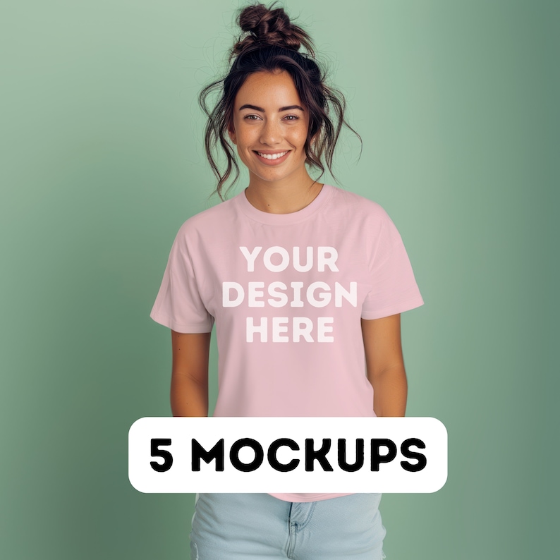 May include: A woman wearing a pink t-shirt with the text "YOUR DESIGN HERE" printed on the front. The t-shirt is a mockup for a design project. The image is labeled "5 MOCKUPS".
