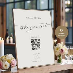 May include: A rectangular sign with the words "PLEASE KINDLY take your seat" in cursive. It features a QR code and the names "ELOUISE and BECKETT" with a date. A circle indicates "6 SIZES INCLUDED". The sign is on a wooden table.