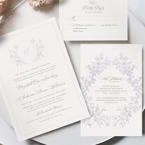 May include: Elegant wedding invitation suite with floral accents. The set includes an invitation, RSVP card, and details card, all in a soft, neutral color palette. The invitation features the names of the couple and wedding details.