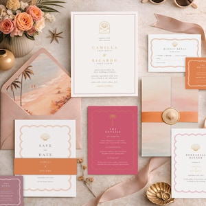 May include: A flat lay of wedding stationery, including invitations, RSVP cards, and a rehearsal dinner card. The color palette includes shades of pink, peach, and gold. A bouquet of flowers and sunglasses are also present.