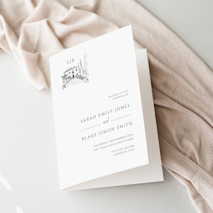 May include: A white wedding invitation with a black and white illustration of a building with a balcony and trees. The text reads "Welcome to the wedding of Sarah Emily Jones and Blake Simon Smith, Saturday, September 12th, Two Thousand & Twenty XXXX, Villa del Milana, Sorrento, Italy."
