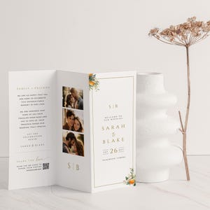 May include: A wedding invitation with a white background and gold accents. The invitation features a floral design with orange blossoms and green leaves. The text on the invitation reads "Welcome to our wedding, Sarah & Blake, Sat 26 Aug, Palm Beach, Florida".