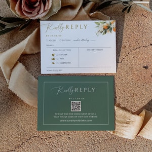 May include: A white RSVP card with green and gold accents. The card has a floral design with orange blossoms and green leaves. The text on the card reads "Kindly Reply" and includes a section for guests to RSVP, choose their meal selection, and indicate any dietary needs. A second card with a green background and a QR code is included. The text on the second card reads "Kindly Reply" and includes instructions to scan the QR code for more event details or visit the website www.sarahandblake.com.